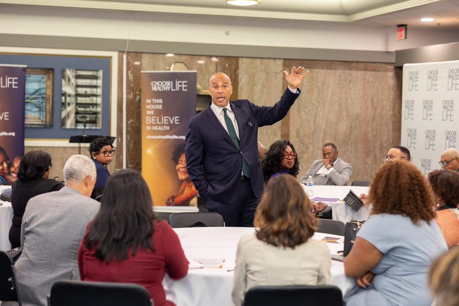 Sen. Cory Booker (NJ) steps into the center of the room to deliver remarks
