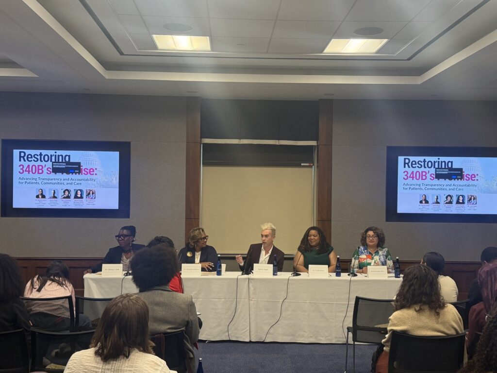 Five panelists seated at a table between two screens reading Restoring 340B’s Promise